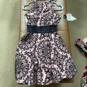 Junior size 1 dress brand new with tags. Pink with black velvet brocade detail.
